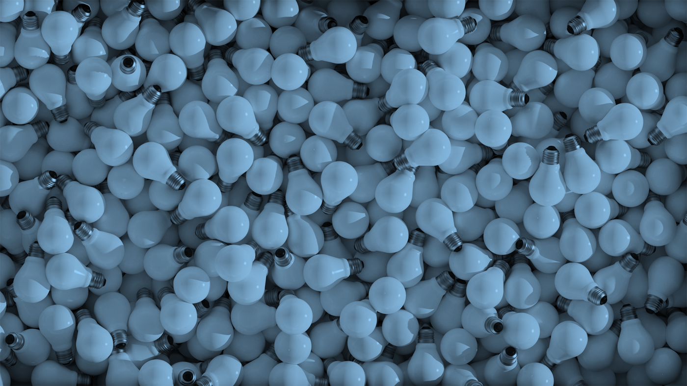 Decorative photo of lightbulbs in a large pile (not connected or lit, and arranged to form a 'wallpaper' image, tinted blue).